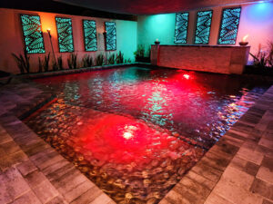 Custom built pool with red lights reflecting off the water in the St. Petersburg, Florida area.