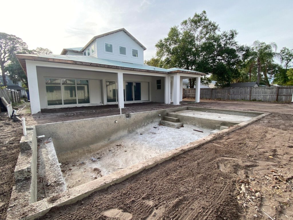 New construction home with a custom pool under construction. | Winway Pools