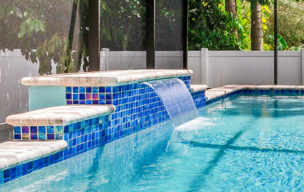Water feature on a custom pool built by Winway Pool on a sunny day.