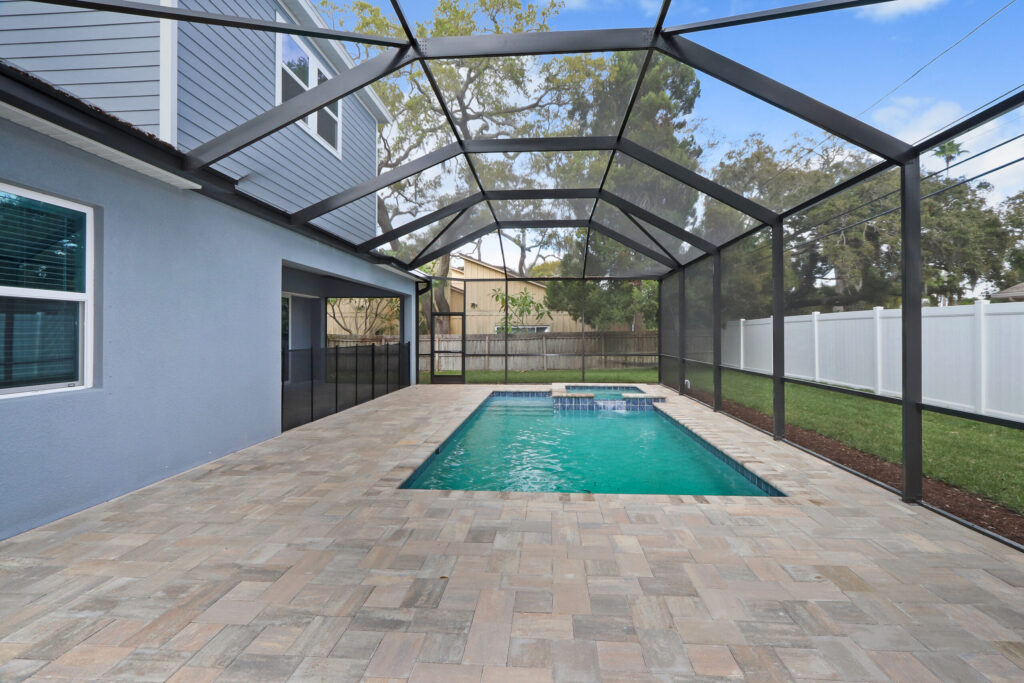Scree enclosure built over custom pool with hot tup in St. Petersburg Florida | Winway Pools