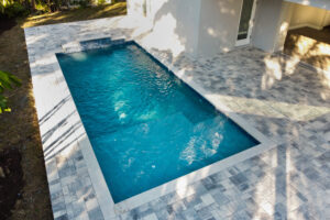 Custom small pool with sunshinre and stone decking | Winway Pools