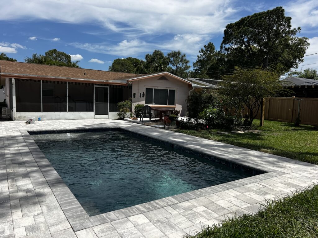 Custom pool rectangle daytime behind house | Winway Pools
