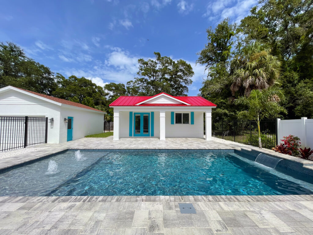 Custom pool with red-roof pool house and gate | Winway Pools