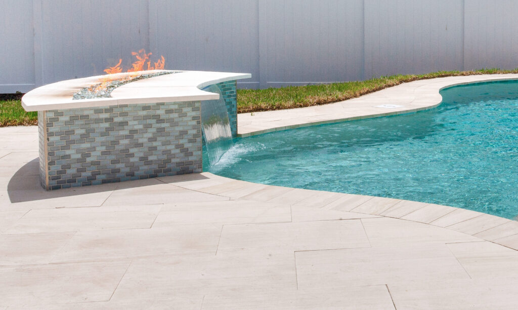 Custom pool with fireplace and waterfall | Winway Pools
