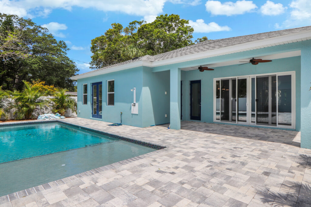 Blue house with custom pool daytime | Winway Pools