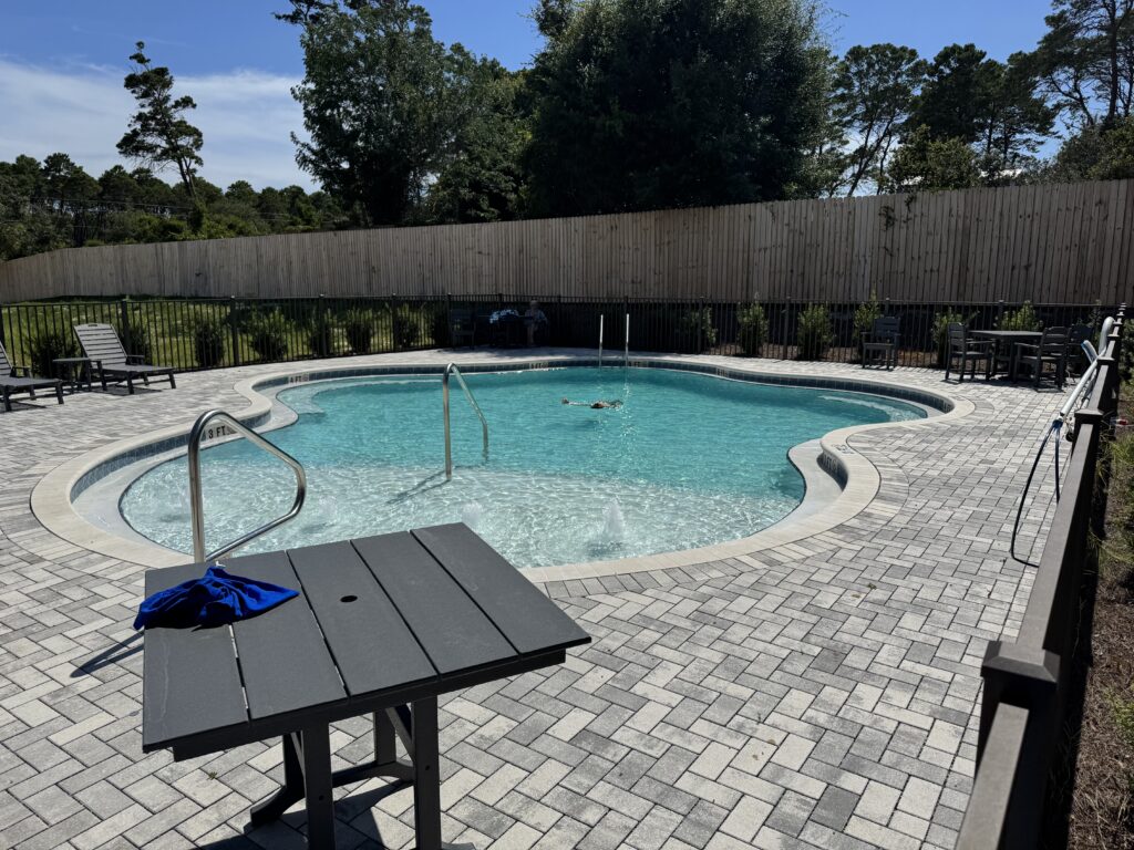 Custom pool and patio with table daytime | Winway Pools