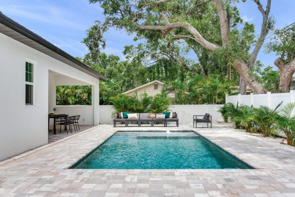 Custom pool in backyard with paver patio | Winway Pools
