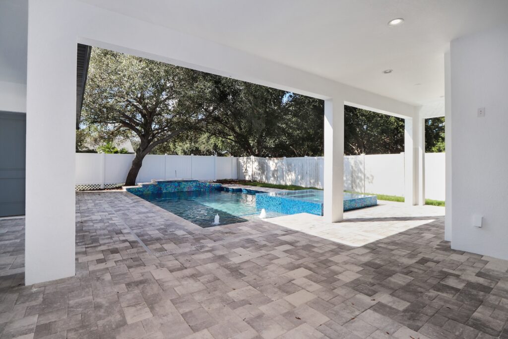 Custom pool with spa on a paver deck | Winway Pools