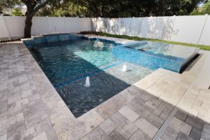 Contemporary Custom Pool by WinWay Pools St. Petersburgh with Bubblers and Spillover Spa with Tiled Patio Under Shade Try